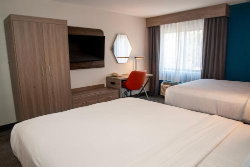 a hotel room with two beds and a desk at Holiday Inn Express Tucson-Airport by IHG in Tucson
