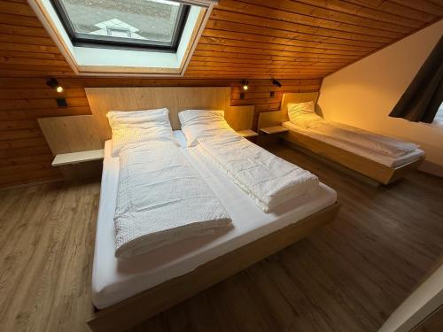 a bedroom with two beds and a window at Pannonischer Traum in Breitenbrunn