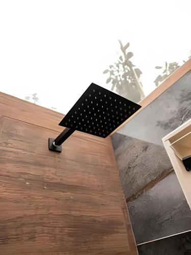 a black bench sitting on top of a wooden floor at Espaço Gaia in Santana do Riacho