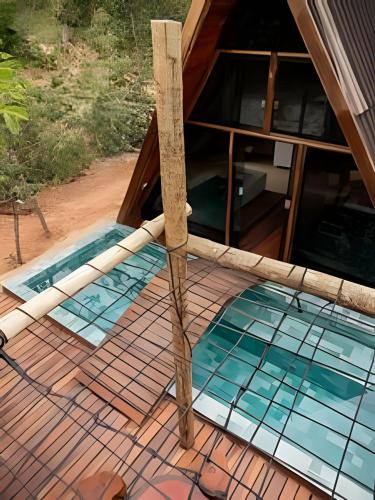 a swimming pool with blue tiles on a house at Espaço Gaia in Santana do Riacho
