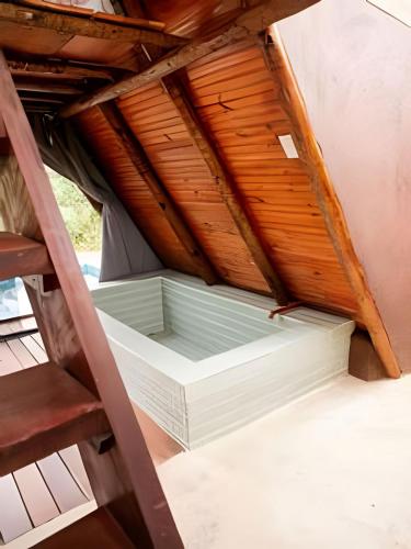 a room under the roof of a house at Espaço Gaia in Santana do Riacho
