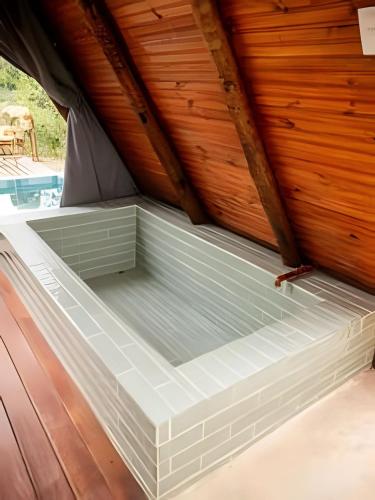 a bed in a tent with a wooden ceiling at Espaço Gaia in Santana do Riacho