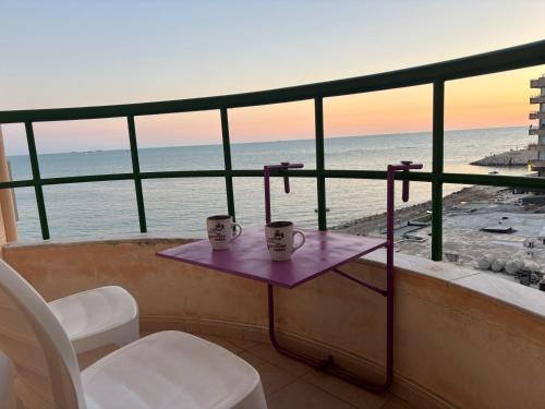 a balcony with a table and chairs and the beach at Balcony on the sea in Durrës