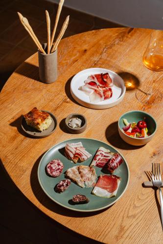 a wooden table with plates of food on it at Tenuta Borgo Santa Cecilia in Gubbio