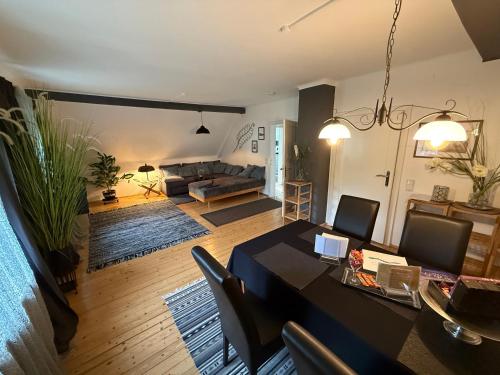 a living room with a table and a couch at Villa Komposch - adults only in Reifnitz