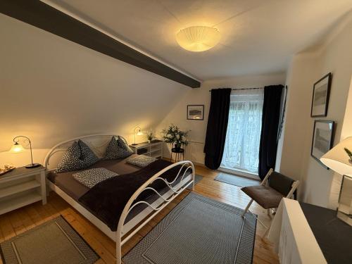 a bedroom with a bed and a desk and a window at Villa Komposch - adults only in Reifnitz