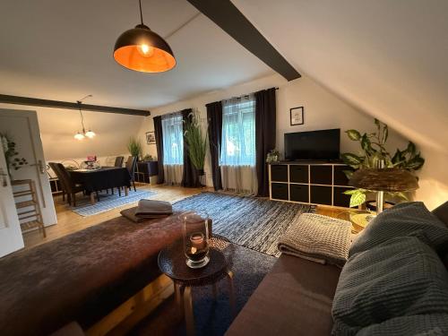 a living room with a couch and a table at Villa Komposch - adults only in Reifnitz