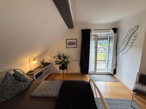 a living room with a table and a window at Villa Komposch - adults only in Reifnitz