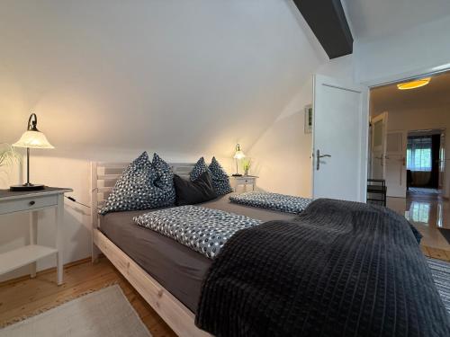 a bedroom with a large bed with blue pillows at Villa Komposch - adults only in Reifnitz