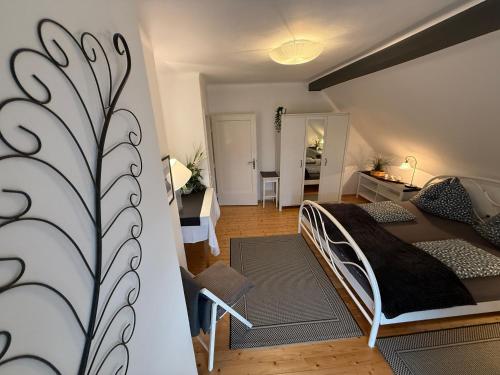 a bedroom with a bed and a living room at Villa Komposch - adults only in Reifnitz