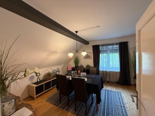 a dining room with a table and chairs in a room at Villa Komposch - adults only in Reifnitz