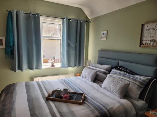a bedroom with a large bed with a tray on it at Felixstowe room lets in Felixstowe