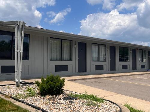 a white building with windows on the side of it at Stay-Well Inn - Monroe in Monroe