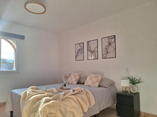 a bedroom with a bed with a blanket on it at La Karina in Denia