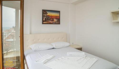 a bed with two white pillows in a room at Lotos - stan 423 in Dobra Voda