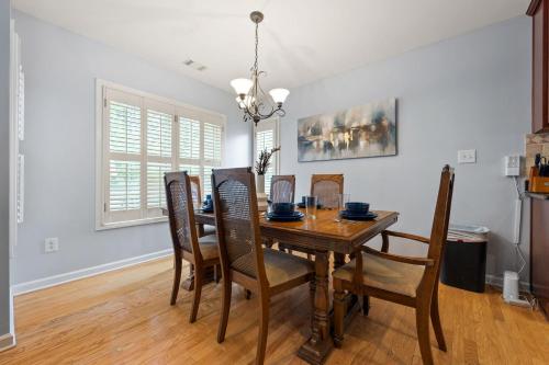 a dining room with a wooden table and chairs at Relaxing 3BR Duplex Home w/ Pool & Patio in Buford