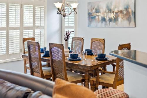 a dining room with a wooden table and chairs at Relaxing 3BR Duplex Home w/ Pool & Patio in Buford