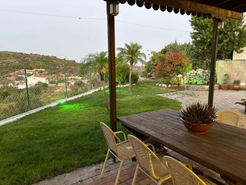 a wooden table and chairs on a patio at Casa Maria Tsampika in Psinthos