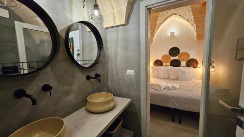 y baño con cama, espejo y lavabo. en Gente di Mare Luxury Home, en Fasano
