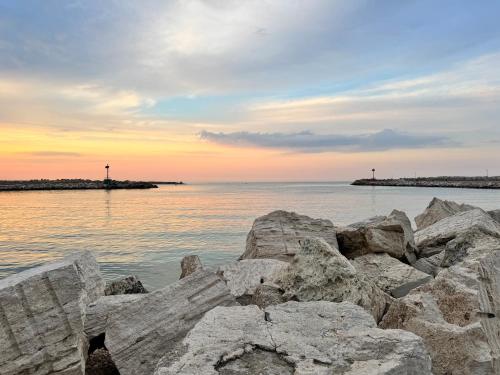 a group of rocks on the water at sunset at Glamping Uma Casanatura in Cellino Attanasio