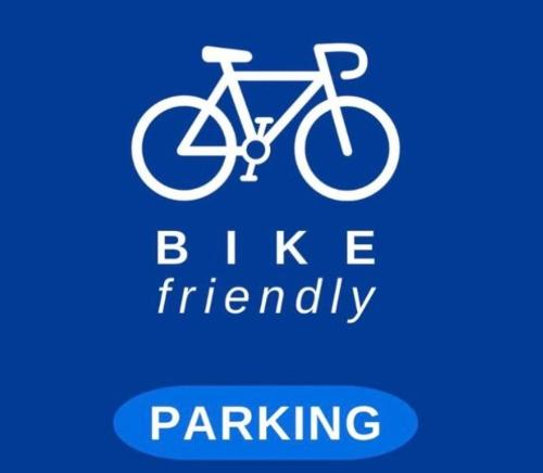 a white bike sign with the words bike friendly at Palazzo Cusani Charming Rooms in Vercelli