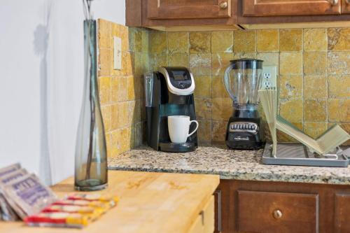 a kitchen counter with a coffee maker and a blender at Pool and Patio, 8 minutes from Mall of Georgia! in Buford