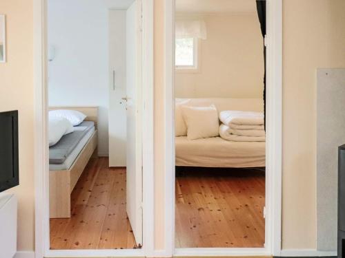 a view of a living room with a couch through a mirror at 4 star holiday home in MELLBYSTRAND in Mellbystrand