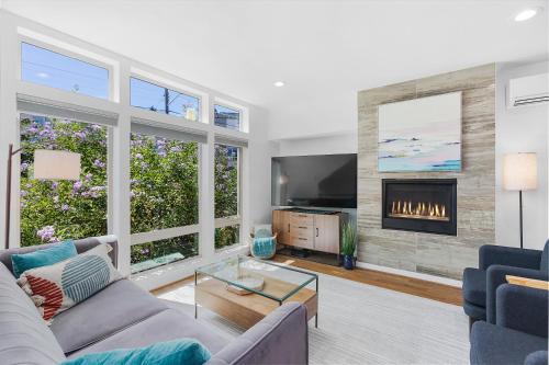 a living room with a couch and a fireplace at Golden Gardens Getaway-Walk to Beach & Waterfront in Seattle