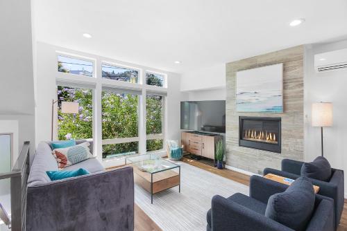 a living room with two couches and a fireplace at Golden Gardens Getaway-Walk to Beach & Waterfront in Seattle
