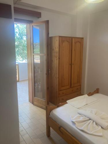 a bedroom with a bed and a sliding glass door at Liberty-Studio Ν5 in Georgioupolis