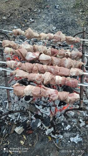 a bunch of meat cooking on a grill at Mamukas guest house glola in Glola