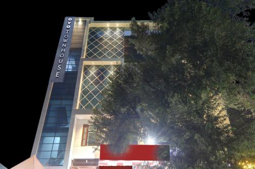 a tall building with a tree in front of it at Super Collection O Hotel Blueline in Juhi Bari