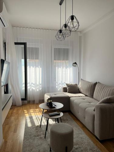 a living room with a couch and a table at Apartman Relax in Arandelovac