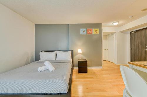 a bedroom with a bed with a towel on it at RivetStays - The Pantages Suite in Toronto