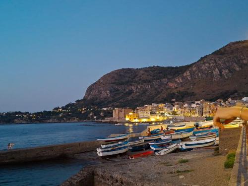 a group of boats on the shore of a beach at Casa Mirella in Aspra