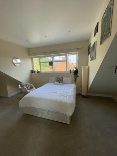a bedroom with a large bed and a window at Marble House in Edgware