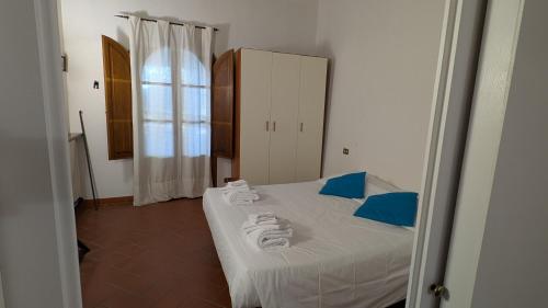 a bedroom with a bed with towels on it at Agriturismo Amici Miei in Marliano