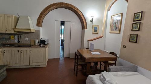 a kitchen and a dining room with a table and a kitchen at Agriturismo Amici Miei in Marliano