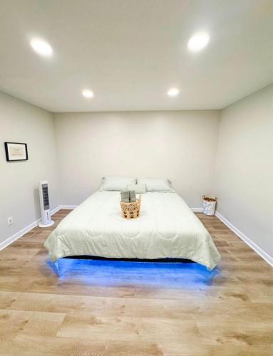 a bedroom with a bed with a blue lighted floor at Emperors Pool House in Jacksonville
