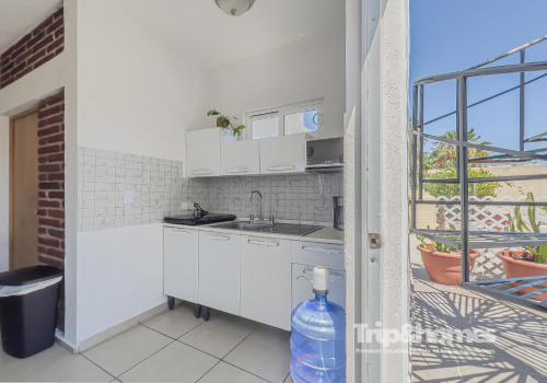 a kitchen with white cabinets and a sink at Sea View Terrace 1BR Apartment 1 Block to Malecón in La Paz