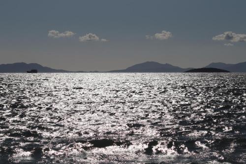 a large body of water with mountains in the background at SeasoundStudios in Agios Stefanos