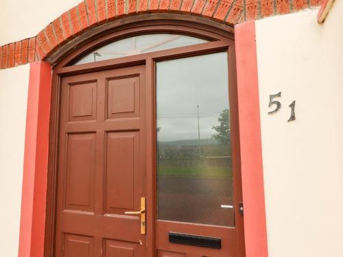a door to a building with the number at 51 Woodview Park in Tralee
