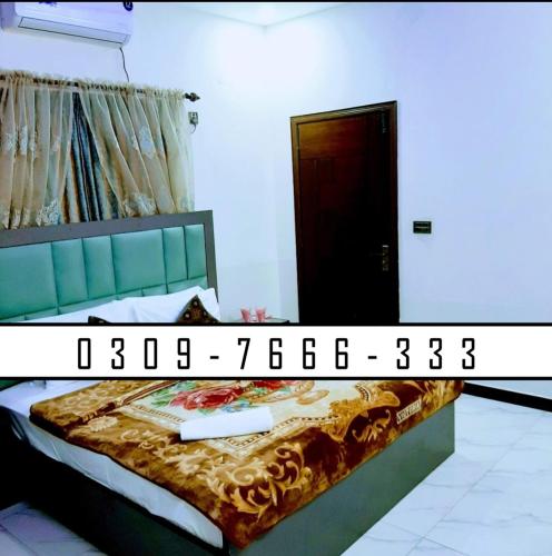 a bedroom with a bed and a black door at The Serenity Inn Family Hotel in Karachi