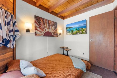 a bedroom with a bed and two pictures on the wall at Lewis Ave Lodge in Tahoma