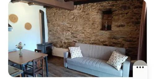 a living room with a couch and a table at Casa do Freire - Serra da Estrela in Aguincho
