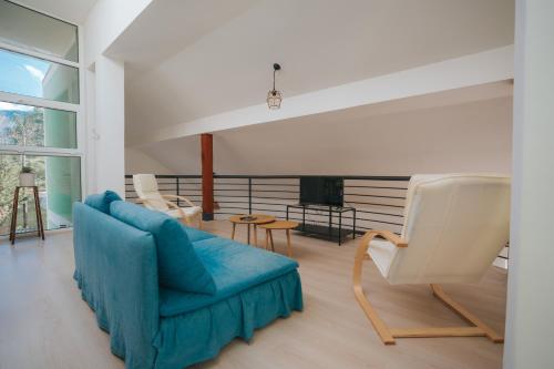 a living room with a blue couch and chairs at Dolce Luxury Villa in Nižepole