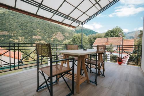 a table and chairs on a balcony with a view at Dolce Luxury Villa in Nižepole