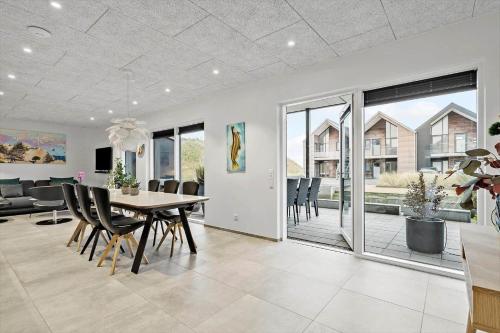 a dining room with a table and chairs at 9929-Hvide-Sande-Langsand-194-stuen in Hvide Sande