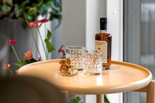 a bottle of wine sitting on a table with glasses at 9929-Hvide-Sande-Langsand-194-stuen in Hvide Sande