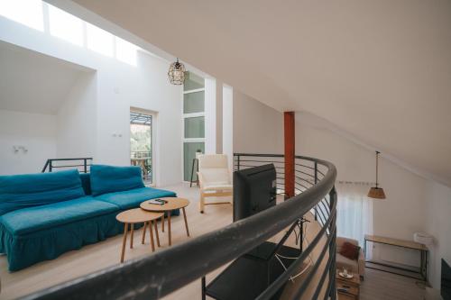 a living room with a blue couch and a table at Dolce Luxury Villa in Nižepole